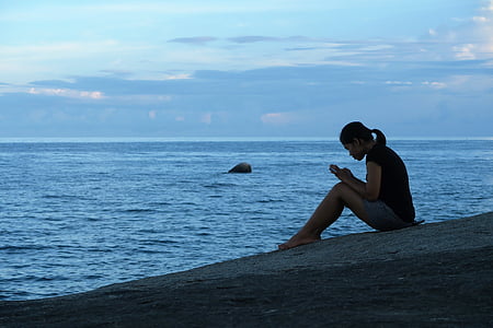 woman sitting beside seashore thumbnail