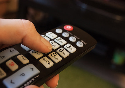person holding black remote thumbnail
