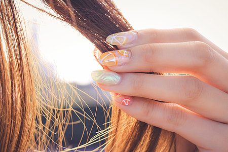 selective focus photography of girl holding her blonde hair thumbnail
