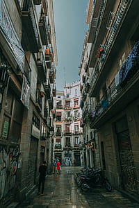 Low Angle Shot of Two People Walking on Alley thumbnail
