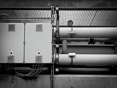 grayscale photo of pipes with gauges thumbnail