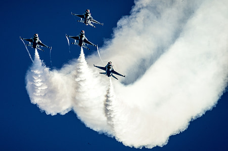four gray planes leaving white contrails thumbnail