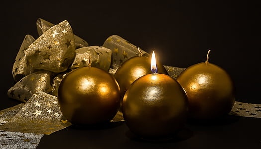 four brown candles on black background thumbnail