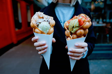 woman holding two crepes thumbnail