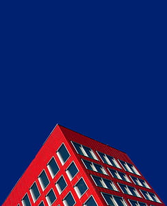 red high-rise building under blue sky thumbnail