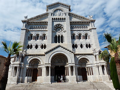 low-angle photography of gray concrete cathedral under cirrus clouds thumbnail