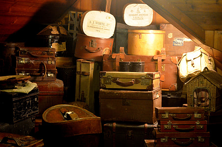 brown and white suitcase lot inside lit room thumbnail