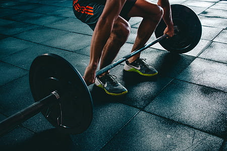 person squatting reaching for barbell thumbnail