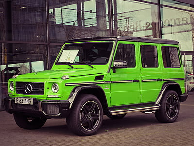 green Mercedes-Benz G-class SUV parked ahead near building thumbnail