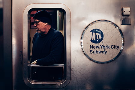 man leaning on MTA New York City Subway train door thumbnail