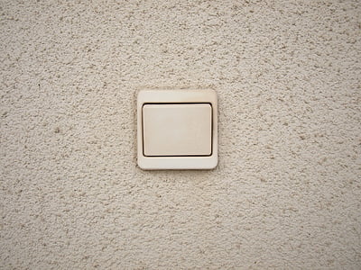 beige switch button on beige concrete surface thumbnail