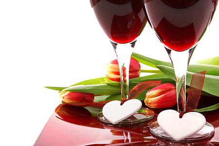 two clear wine glasses near red tulip flowers thumbnail