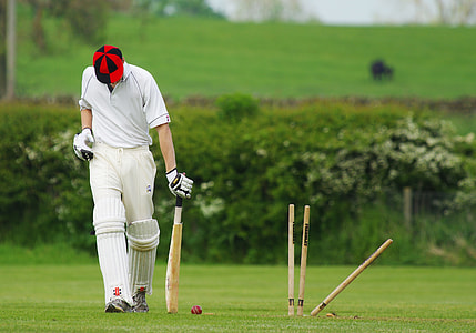 selective focus photography of man holding cricket bat thumbnail