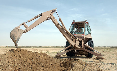 excavator on field digging soil thumbnail
