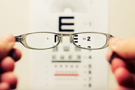 selective focus photography of eyeglass viewing eye chart thumbnail