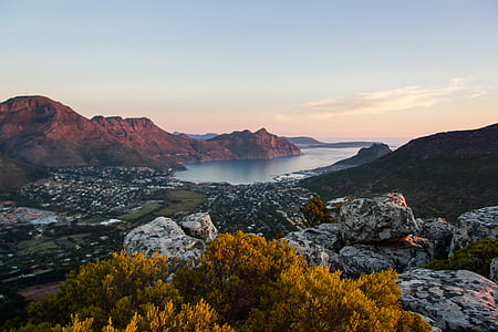 body of water surrounded by mountains during daytime thumbnail