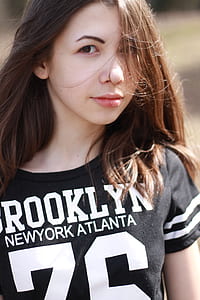 brown haired woman in black and white crew-neck top thumbnail
