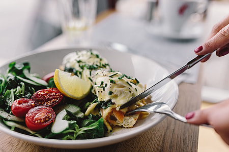 Close up image of young woman eating classic breakfast at restaurant thumbnail