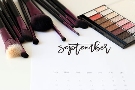 white calendar poster with makeup brushes and eyeshadow palette thumbnail