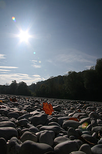 low angle photography of stone field under calming sky thumbnail