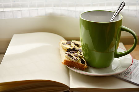 blue ceramic mug on white ceramic saucer beside baked pastry thumbnail