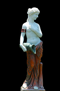 woman in red skirt holding jar with right hand and breast with left hand statue thumbnail