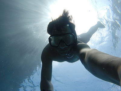 underwater photo of man wearing black framed goggles thumbnail