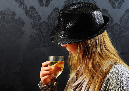 woman holding clear glass goblet thumbnail