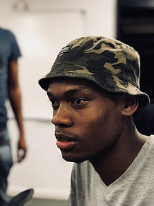 Man Wearing Woodland Camouflage Bucket Hat thumbnail