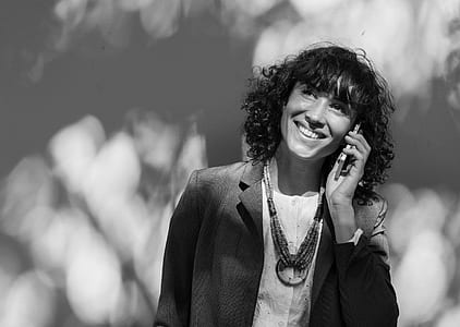 woman calling on phone smiling looking above thumbnail
