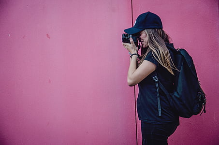woman standing in front of pink painted wall thumbnail