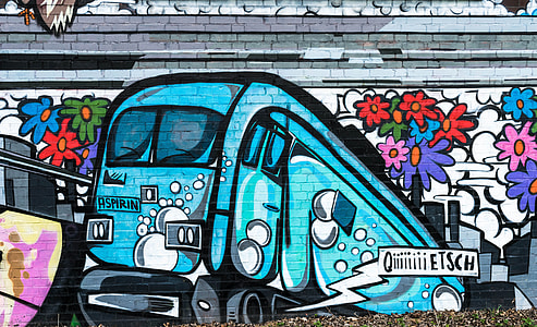 green and white train art on wall at daytime thumbnail