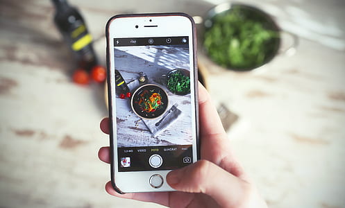 person taking photo of food thumbnail