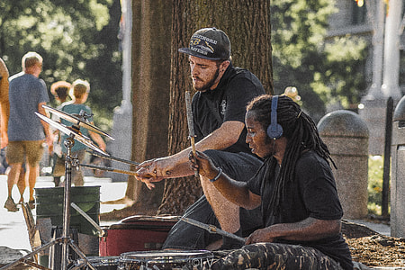 two men playing drum outdoor near trees thumbnail