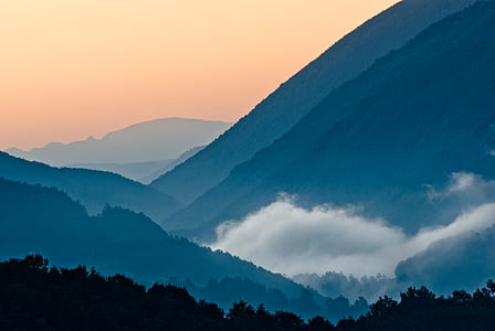 clouds surrounding mountains thumbnail