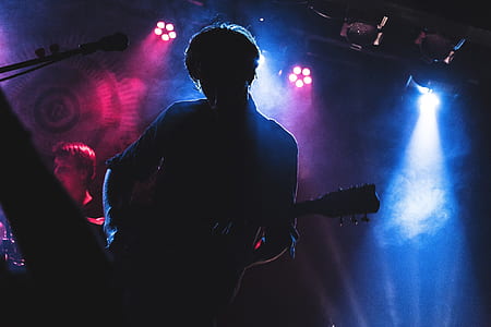 man holding black guitar thumbnail