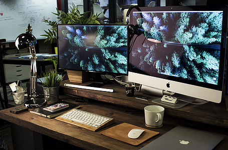 two silver and black flat screen computer monitor turned on thumbnail
