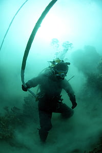 man in diving gear near live rock holding white rope thumbnail