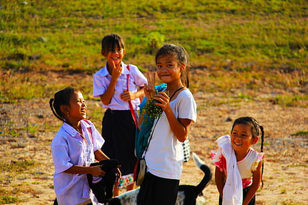 children standing on grass field thumbnail