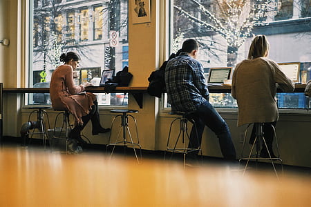 three person sitting on stools thumbnail