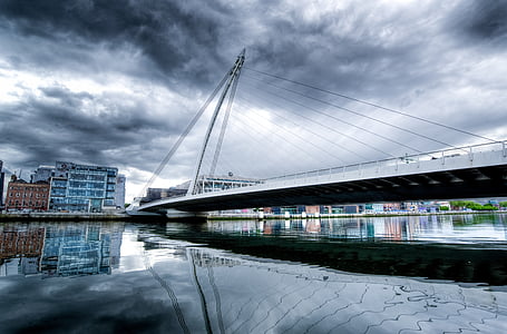 white concrete bridge under clouds thumbnail