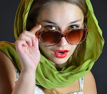 woman wearing green hijab touching oversize sunglasses thumbnail