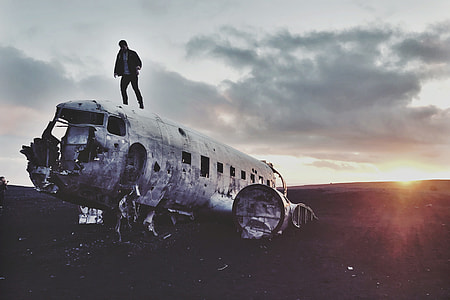 Man standing on an abandoned airplane in Iceland thumbnail