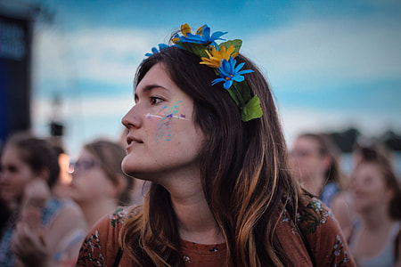 selective focus photography of woman in brown shirt and floral headband thumbnail