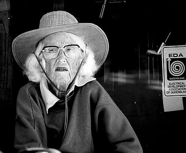 grayscale photo of woman wearing jacket and hat thumbnail