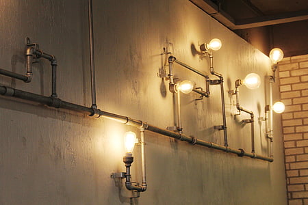 gray metal pipe-themed wall lamp inside room thumbnail