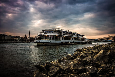 White Ferry Boat by Rocky Shore thumbnail