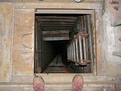 gray steel ladder in brown wooden tunnel thumbnail