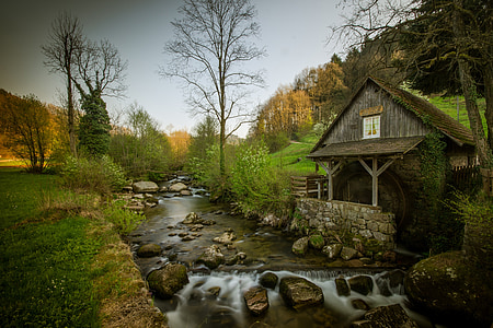 river near gray wooden house at daytime thumbnail