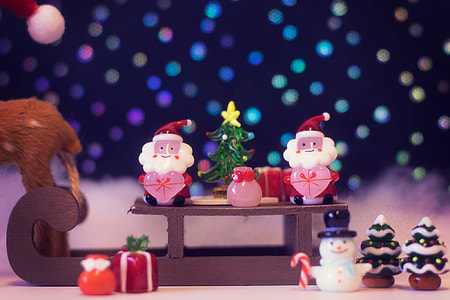 Shallow focus photography of two santas and snowman riding sled figures thumbnail